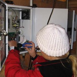 Image: a UCD staff member works on an open module at a sampler site visit.