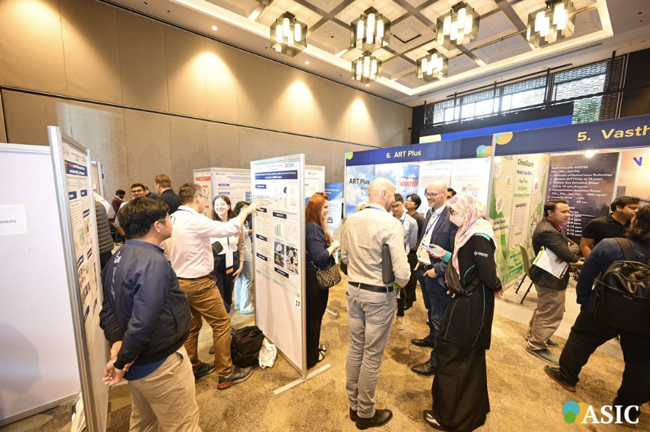 Busy conference exhibition hall with attendees conversing at booths