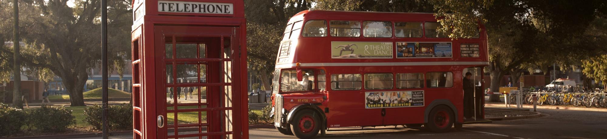 Image: campus grounds with a red vintage phone booth and double-decker bus.
